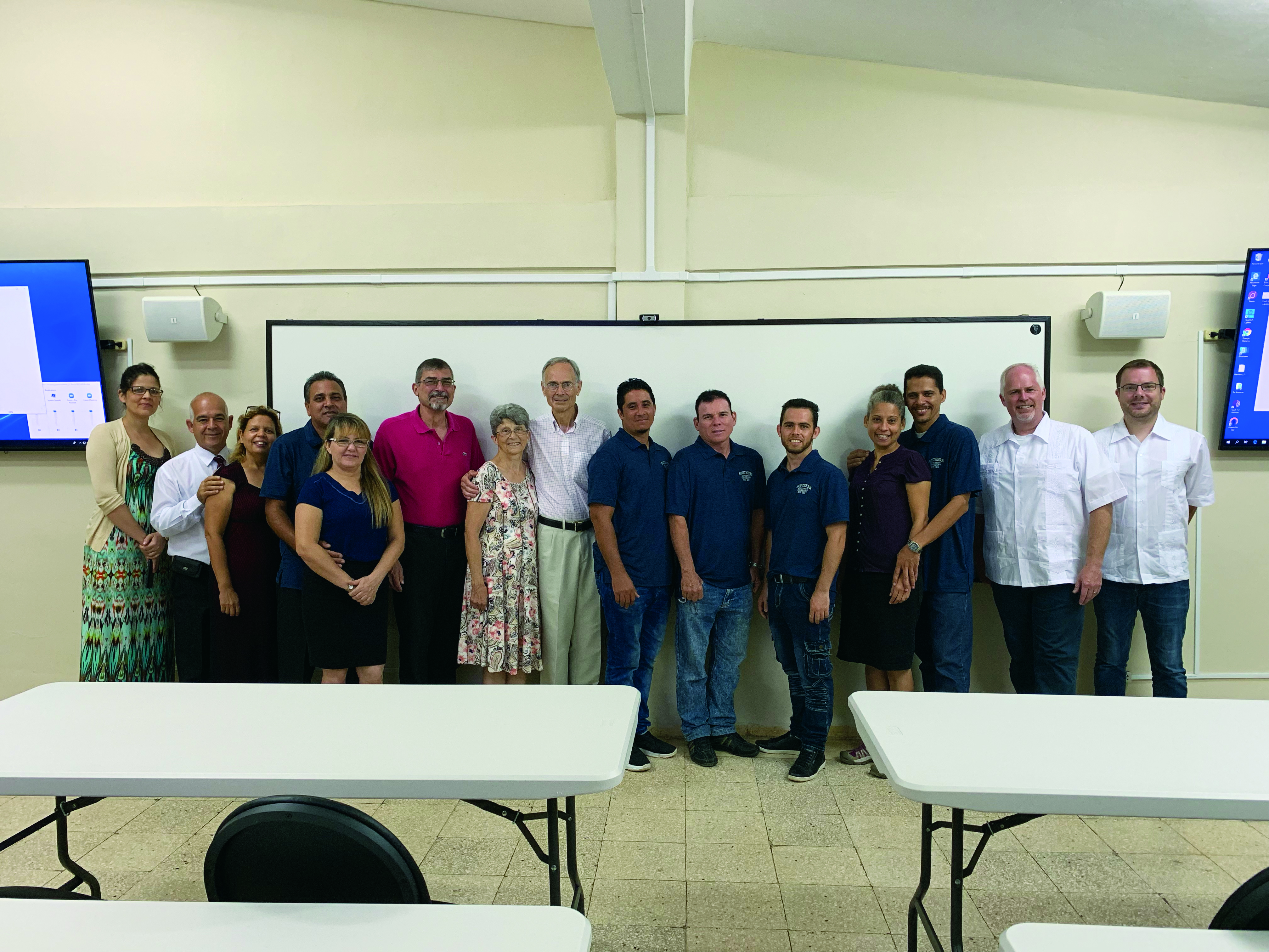Personnel from Southern Adventist University and the Cuba Adventist Theological Seminary pose for a photo in the former storage room that was turned into a virtual classroom.