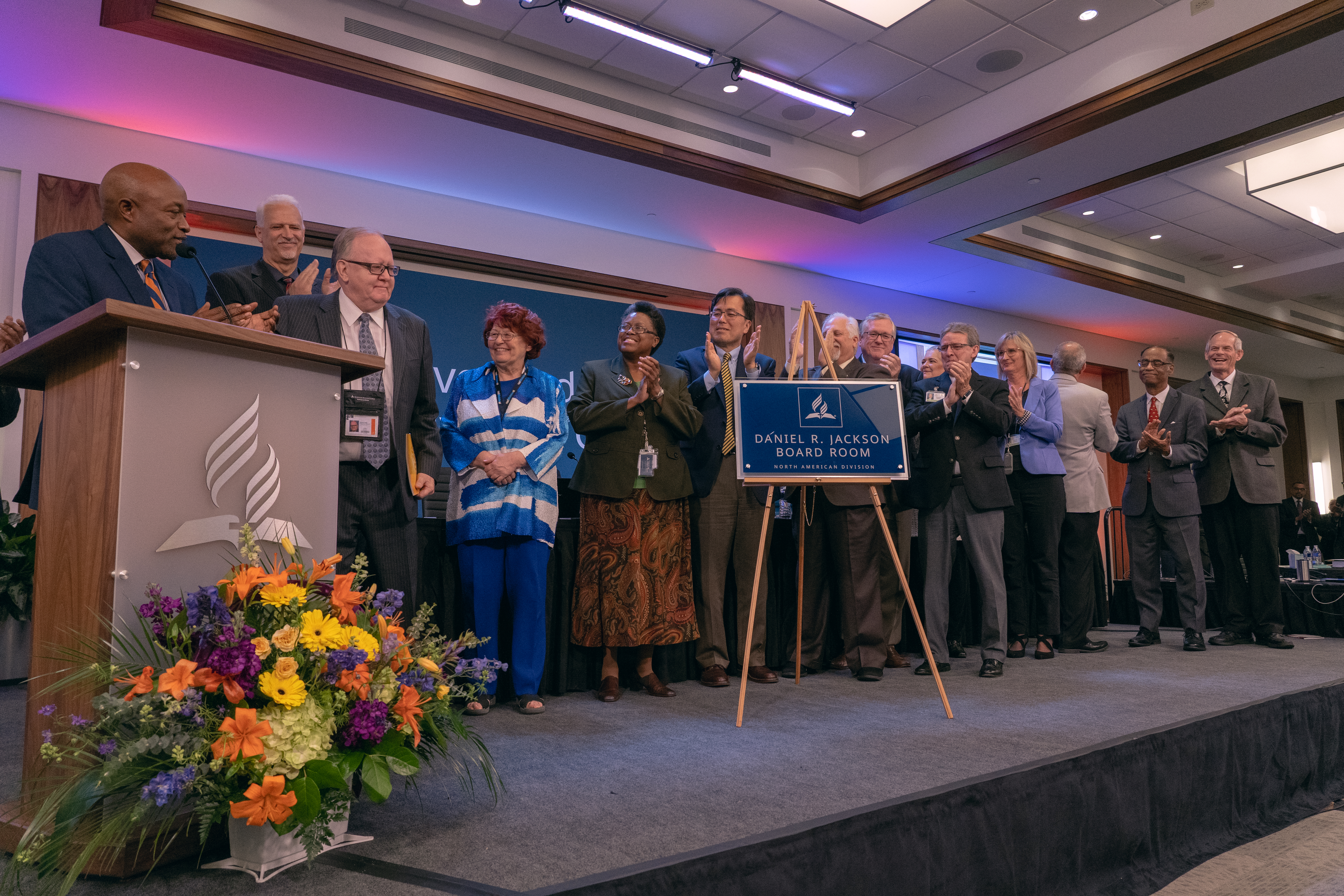 NAD leaders applaud Daniel R. Jackson, president of the NAD, after the unveiling a wall plaque bearing the new name of the building’s executive boardroom — “Daniel R. Jackson Executive Boardroom.” 