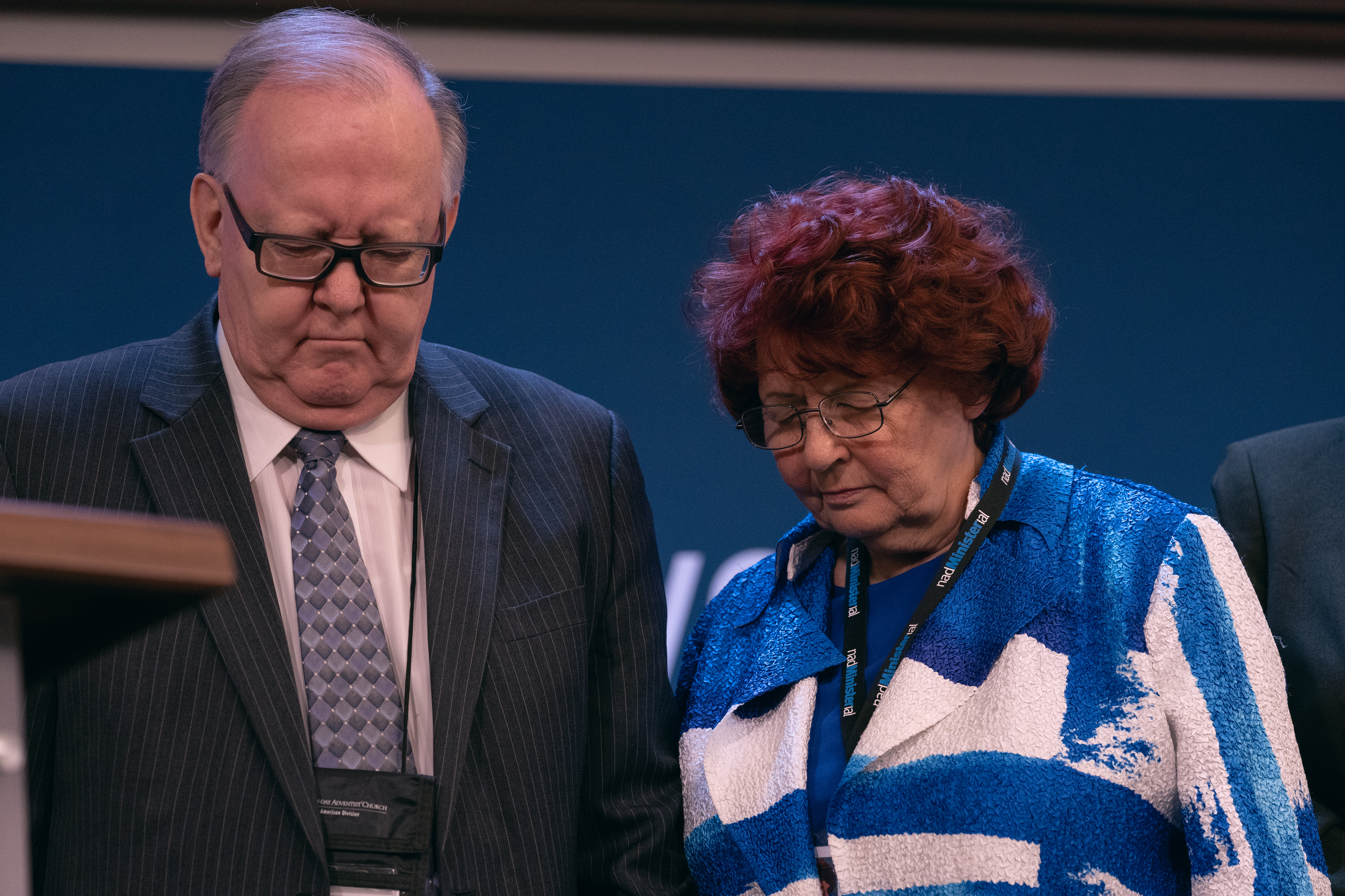 Daniel and Donna Jackson bow their heads during the prayer of dedication over the executive boardroom.