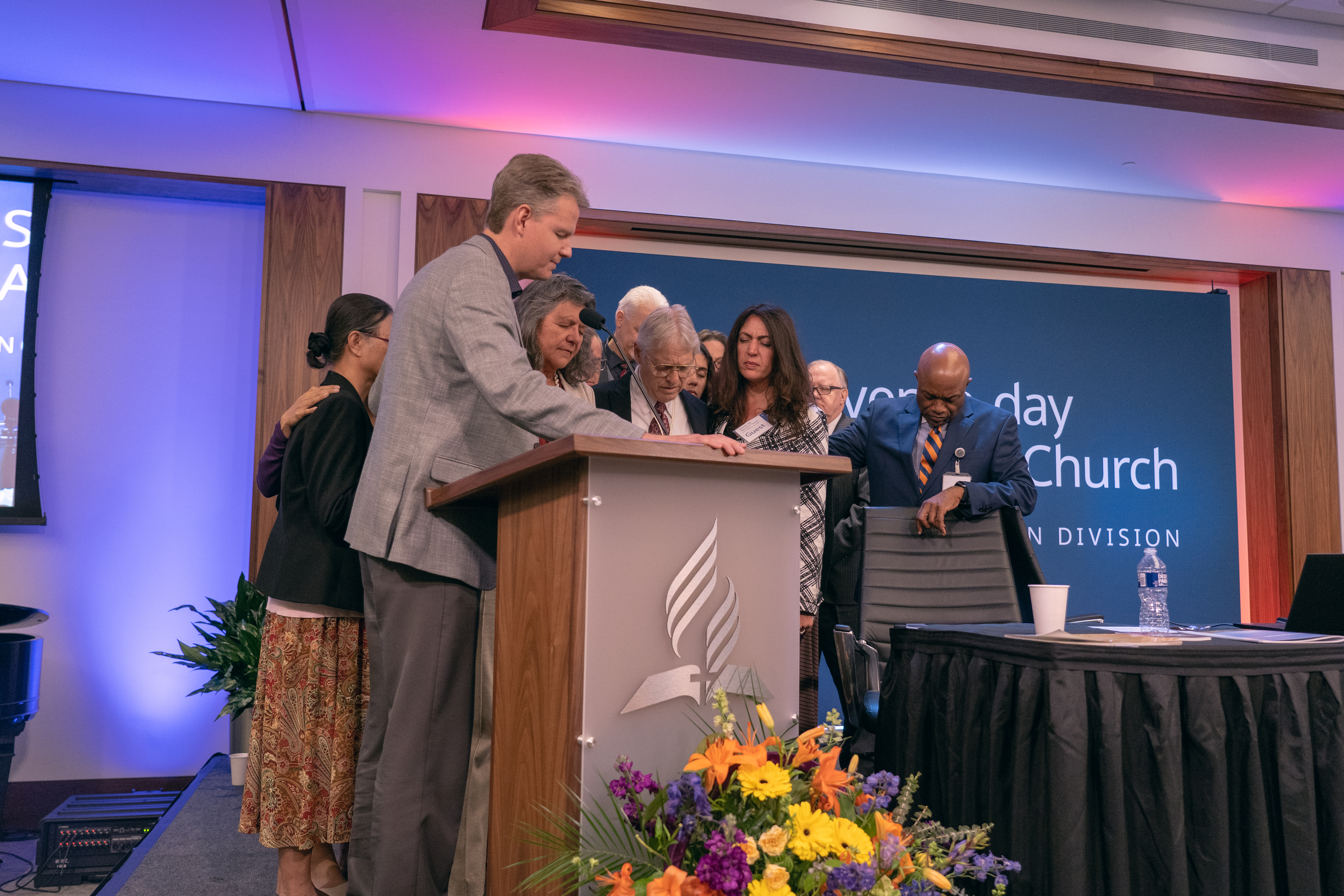 Ken Norton, president of the Guam-Micronesia Mission, prays over the parents, family, and friends of Kirsten Wolcott, the student missionary who was murdered while serving on the island of Yap 10 years ago.