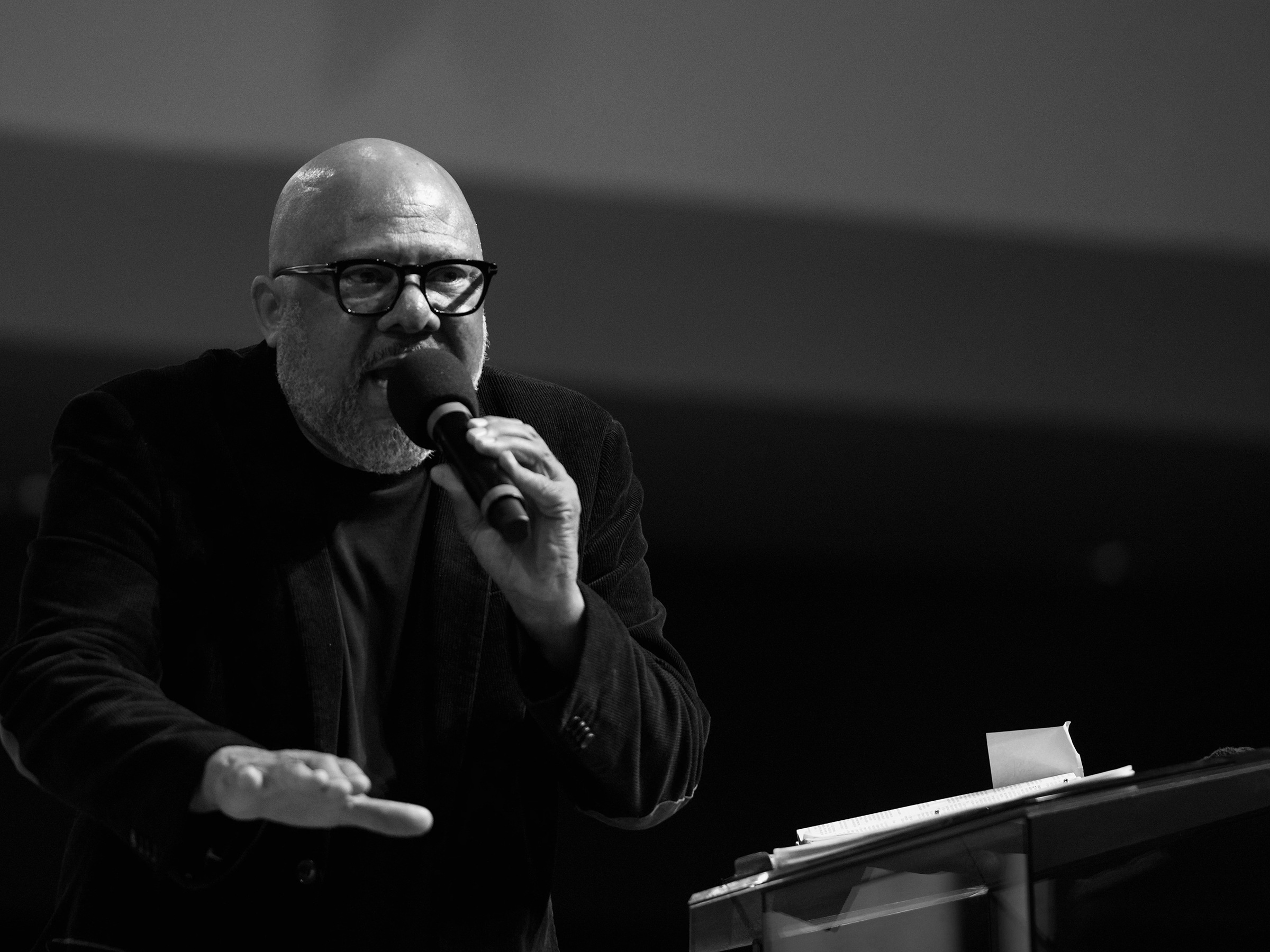 Black-and-white photo of a Black man with his right arm outstretched in front of him