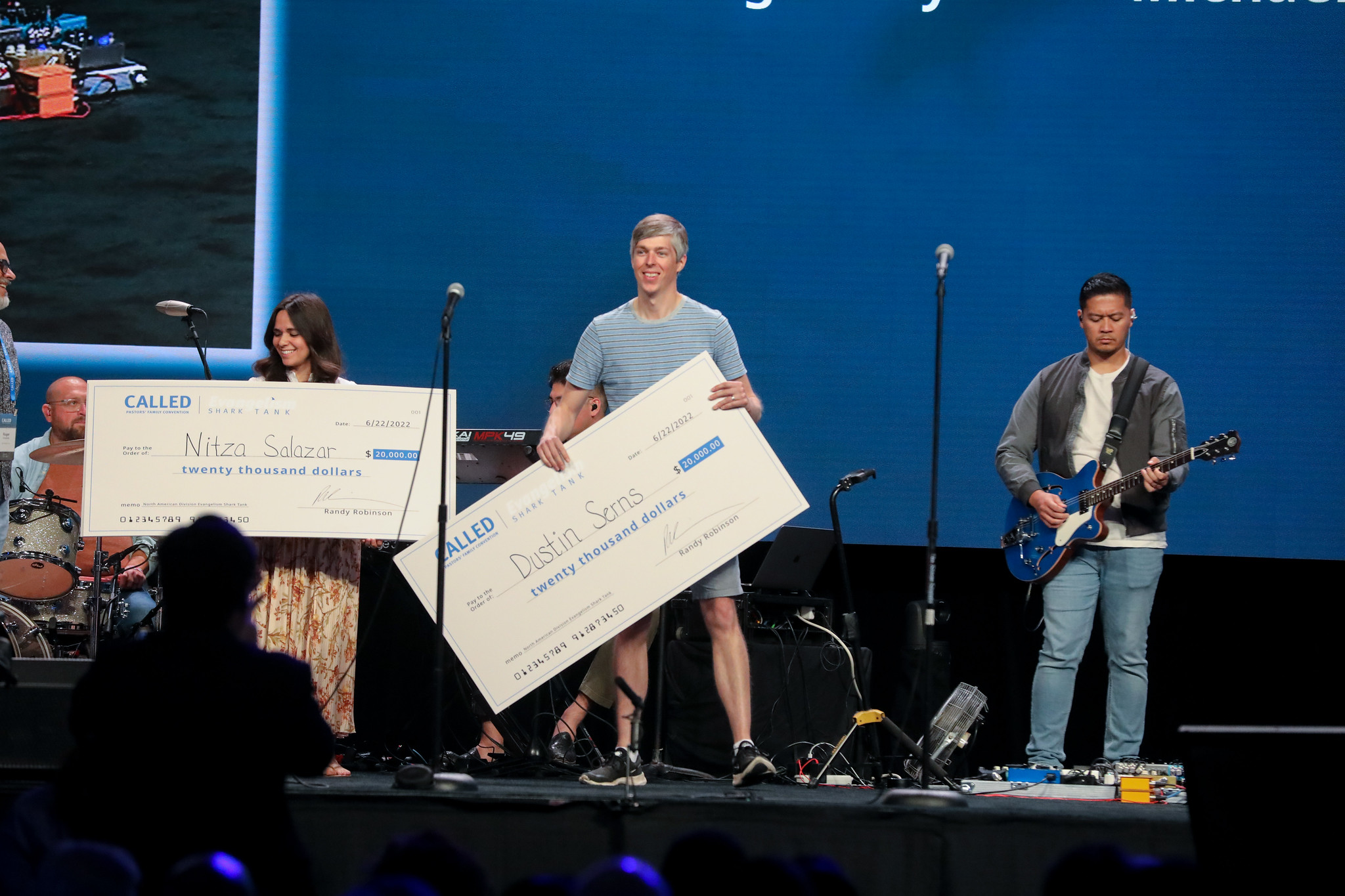 Dustin Serns receives a $20,000 check for his evangelistic effort to plant churches through free health clinics. Photo by: Heidi Baumgartner | North American Division