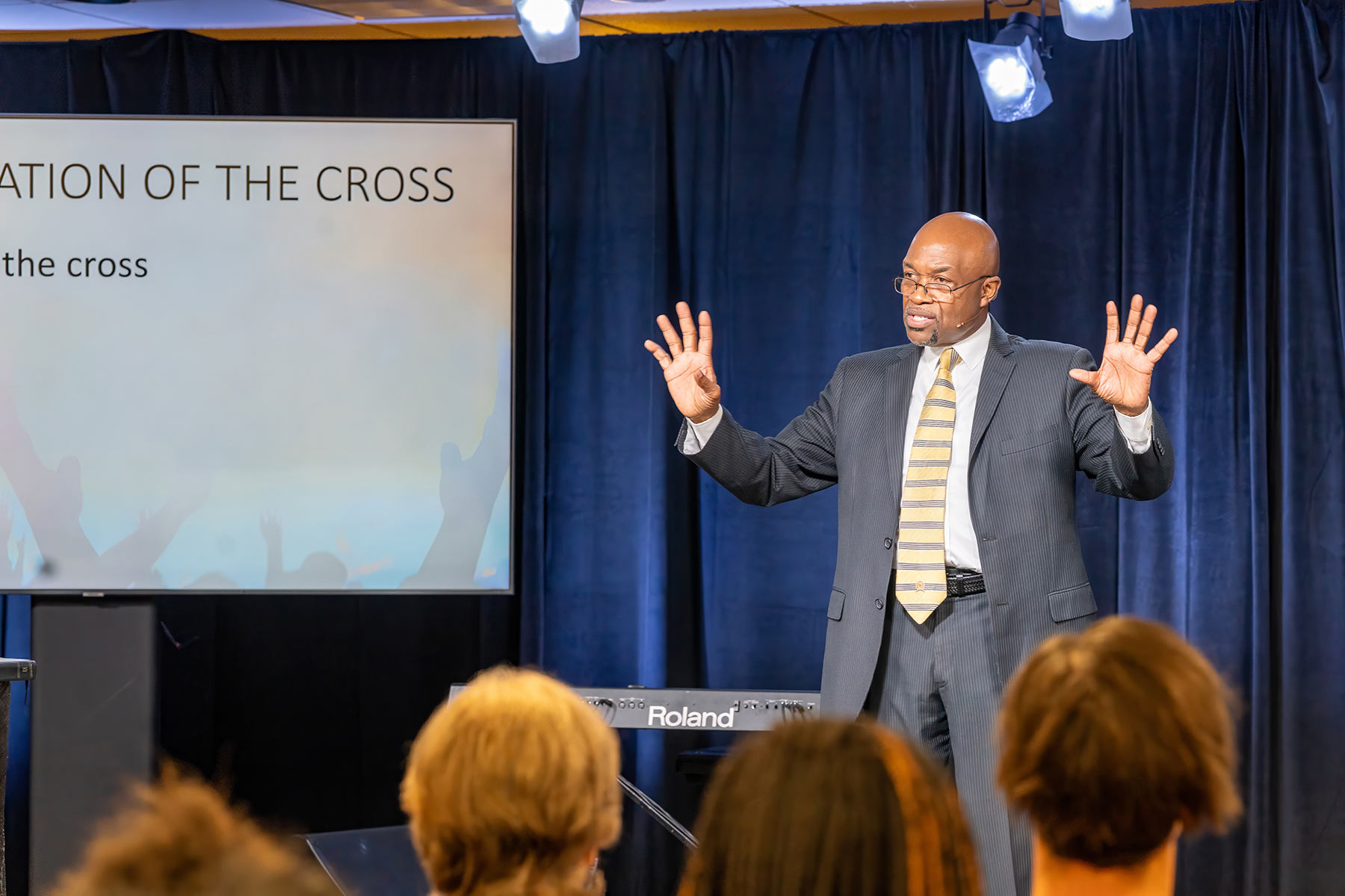 Black man preaching in front of a crowd