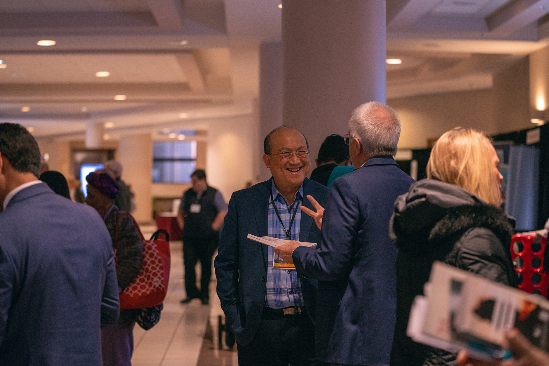 Friends share a laugh in the exhibit hall of the North American Division's Adventist Ministries Convention. 