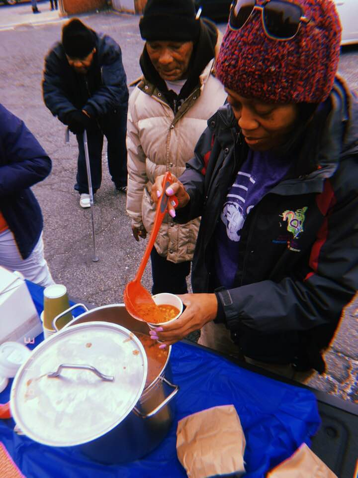 Gael Murray scoops soup to serve hungry residents of Baltimore, Maryland during Global Youth Day on Saturday, March 17.