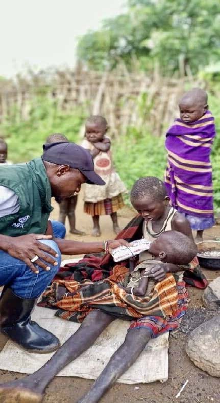 ADRA field worker feeds children in Uganda. Photo: © 2022 ADRA | Uganda
