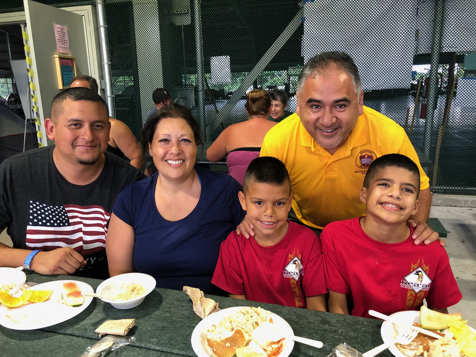 Pastor Rene Lopez encourages a family staying in one of the shelters on Big Island after they lost their home in the recent lava flow