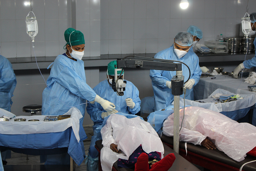 Dr. Jacob Prabahkar (center) performs a cataract surgery.