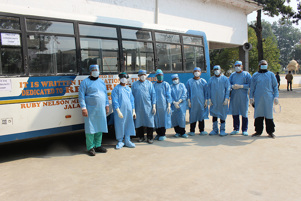 The eye camp staff in front of their bus, made possible by It Is Written donations!