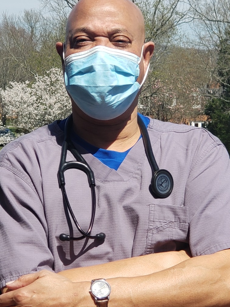 Wayne Moore, an emergency medicine physician, wears a mask as he prepares for work. He says he has been able to survive this time through the prayers and support of his family and friends. 