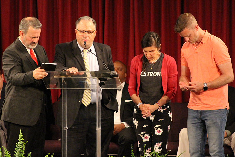 Robert Wagley offers prayer for Mayor Carrie Tergin and Jefferson City, Missouri, as fellas for Pastor Redman (right) and Jody Dickhaut as they serve their communities.