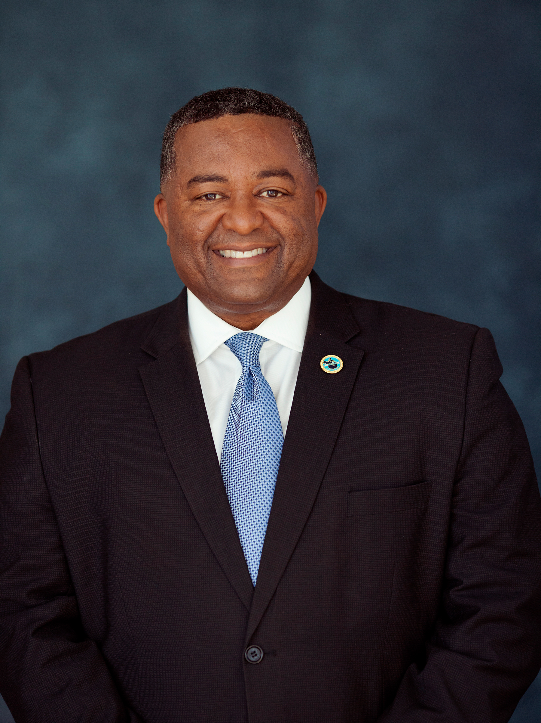 Smiling black man in a suit.