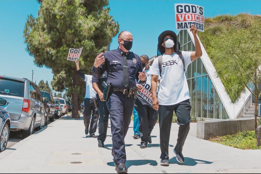 LAPD and Pastor Morris Barnes walk together during a June 3, 2020, march for justice and peace in Los Angeles.