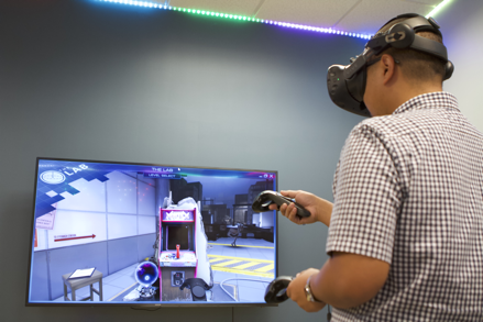 Student tries out a virtual reality video game in La Sierra University’s new virtual reality and artificial intelligence lab. 