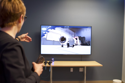 Provost Joy Fehr asks questions before putting on a virtual reality headset
