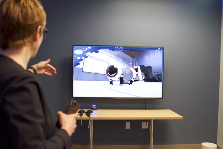 Provost Joy Fehr asks questions before putting on a virtual reality headset 