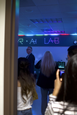 Visitors look around the new VR+AI Lab during a grand opening celebration
