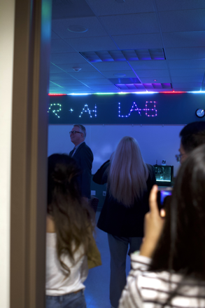 Visitors look around the new VR+AI Lab during a grand opening celebration 