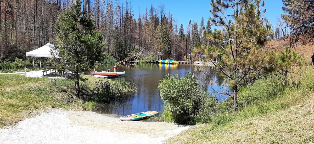 Despite fire damage coming right up to the edge of the lake, a portion of the waterfront area remains accessible. Photo: Northern California Conference