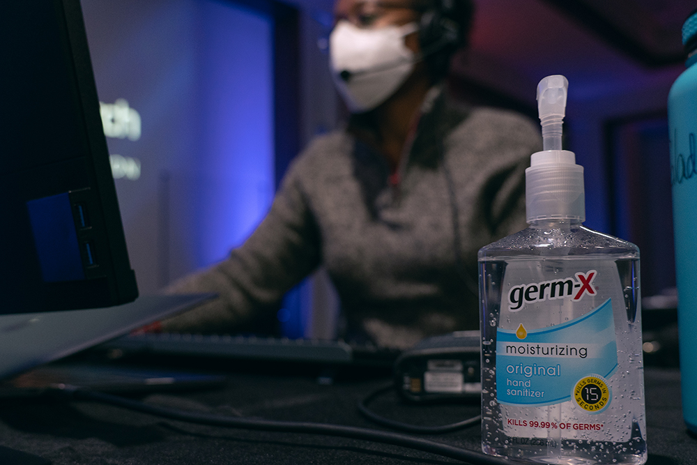 NAD staff member attends the meetings in person, with protective glass, mask, and hand sanitizer on the ready. Photo by Pieter Damsteegt