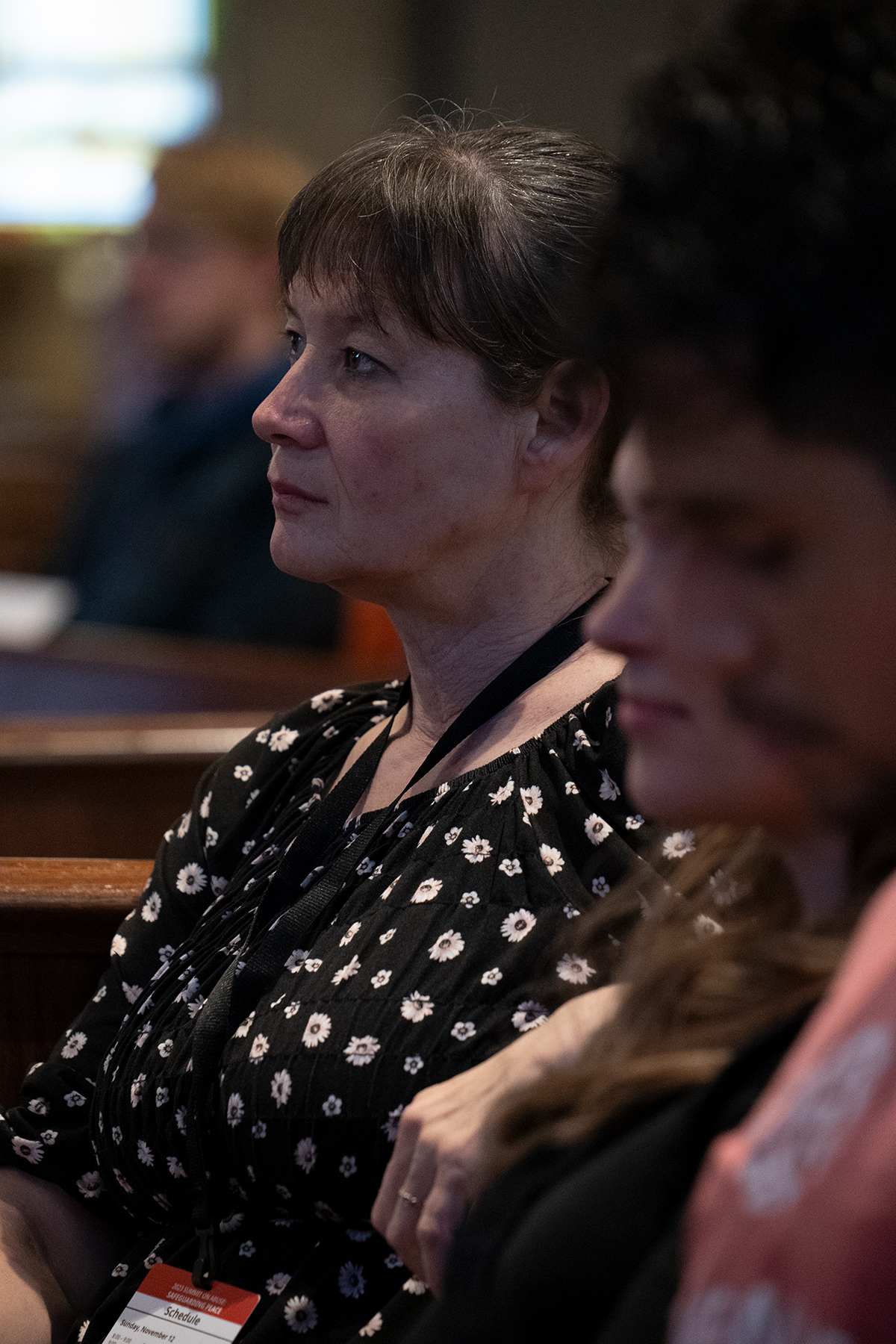 Close-up of a white woman in a seminar listening intently