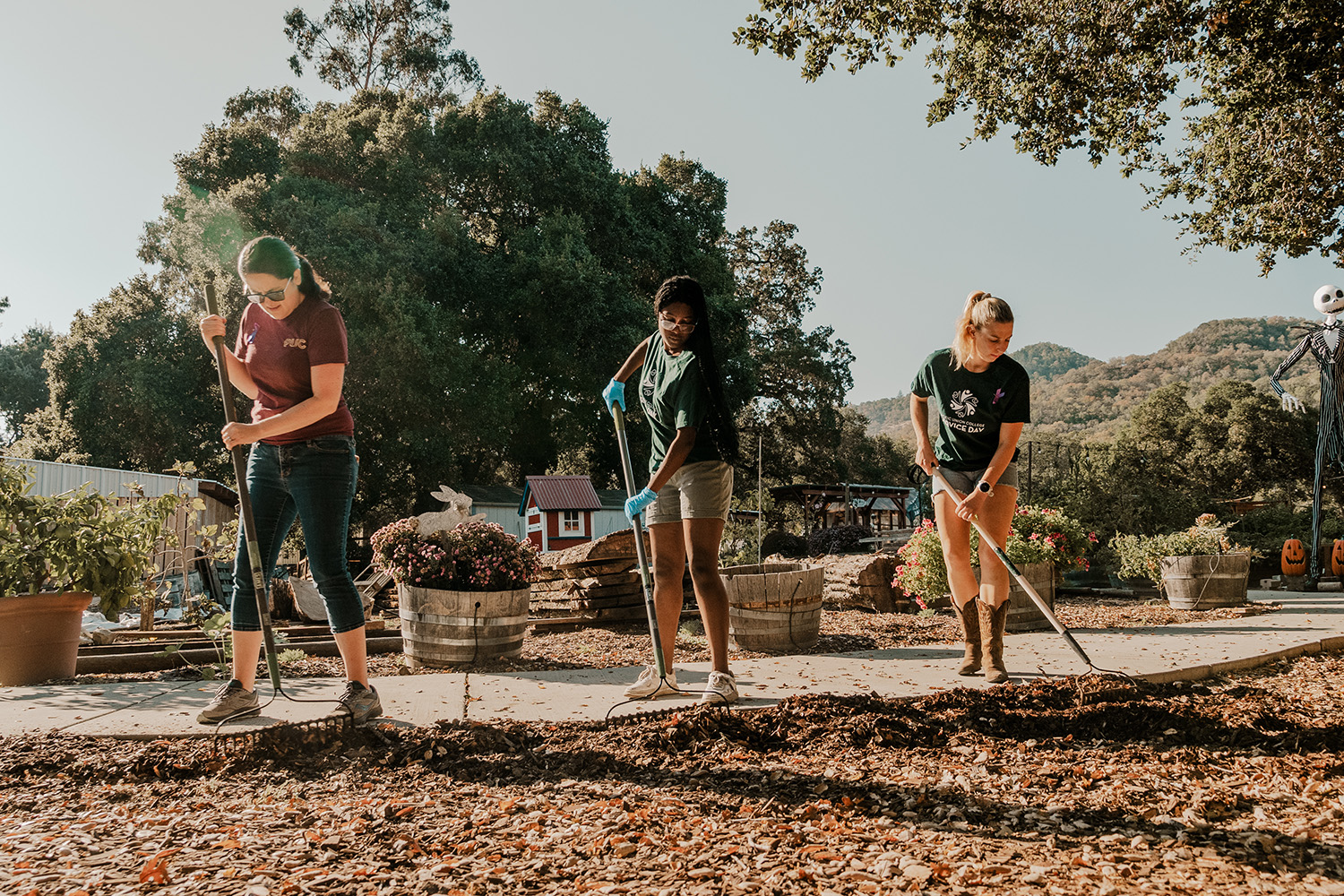 2023 PUC Community Service Day, female students rake leaves