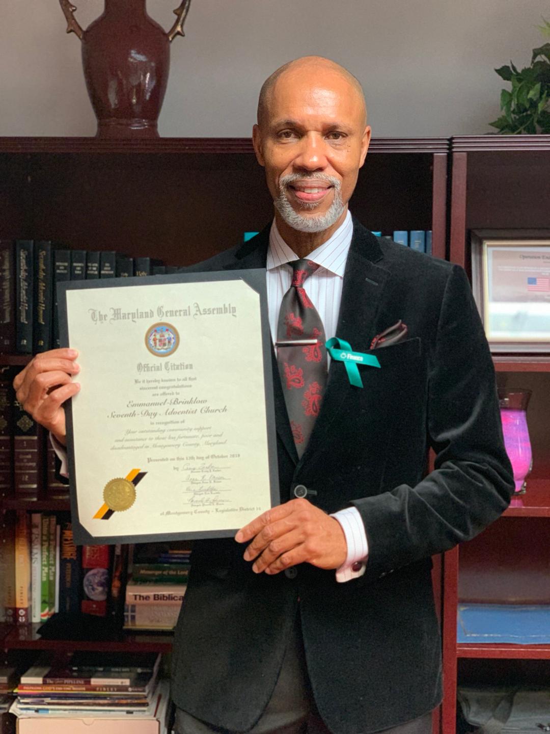 Emmanuel-Brinklow Pastor Anthony Medley displays the citation from the Maryland General Assembly. (Photo: Sheldon Kennedy) 