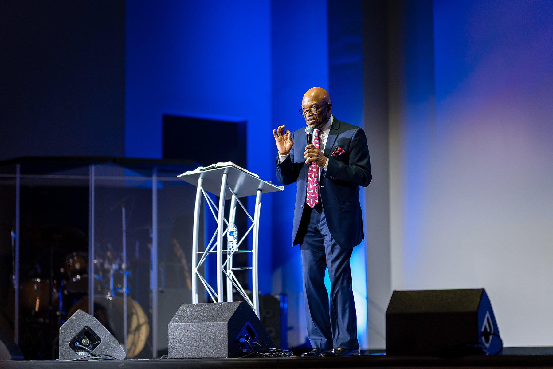 A man stands at a podium speaking