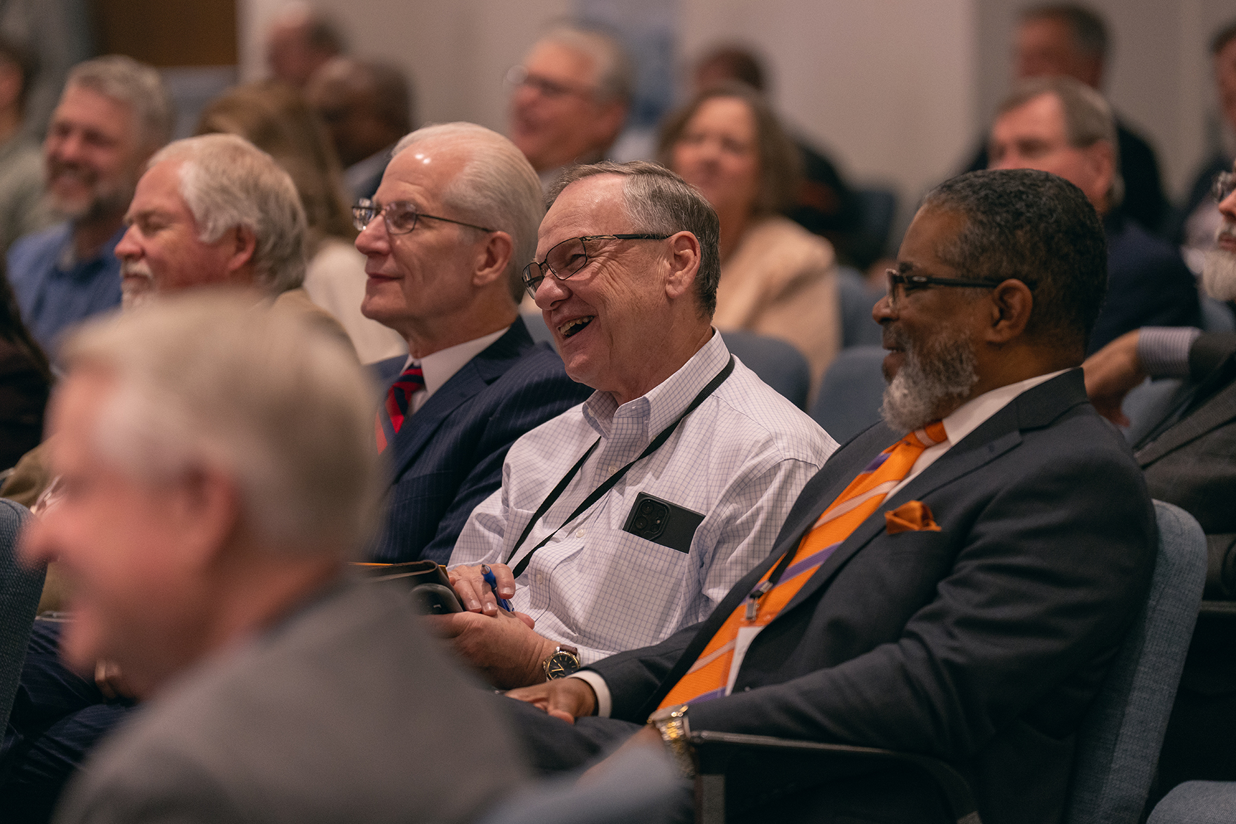 People in a meeting, laughing.