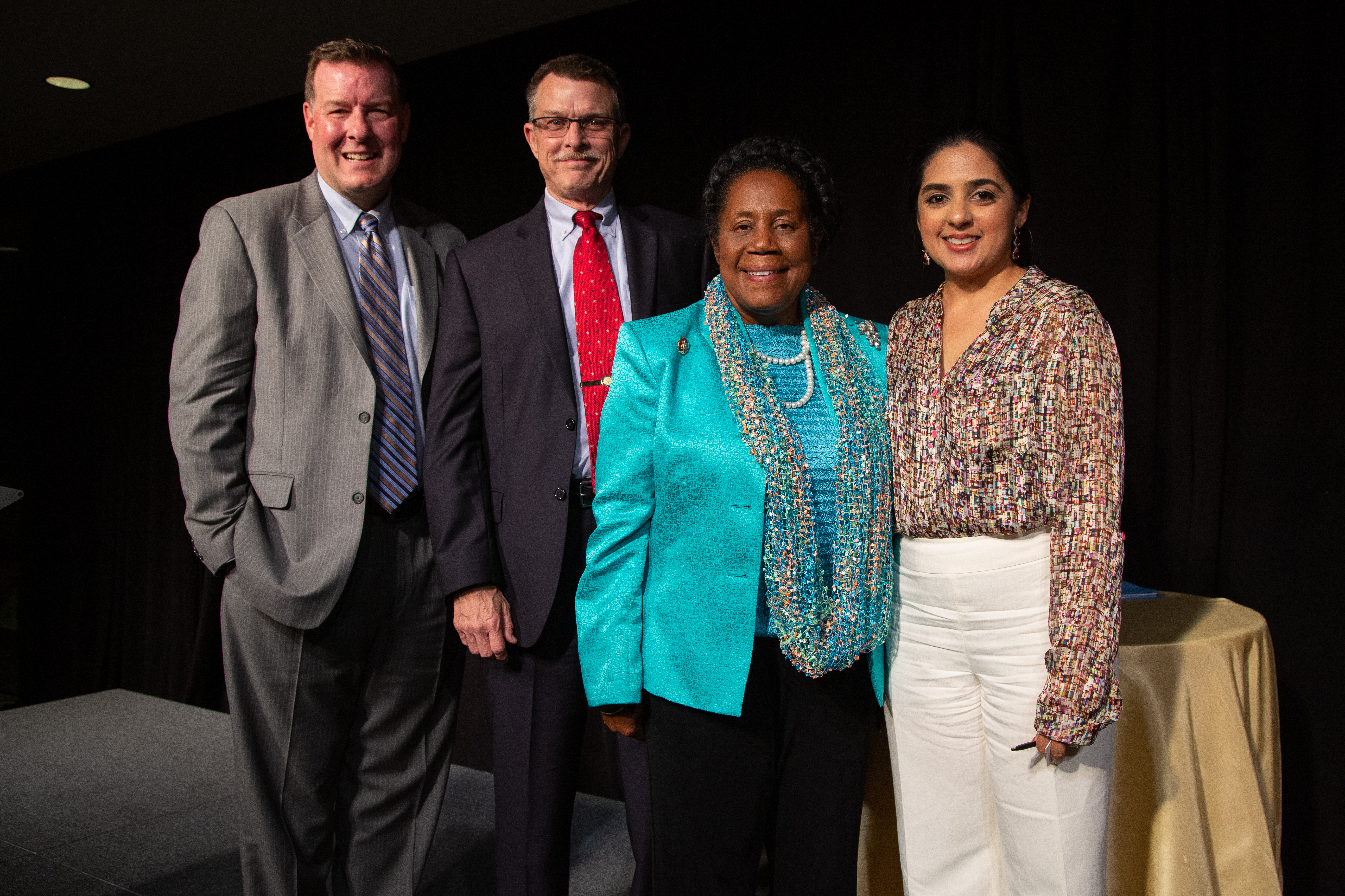 The dinner’s keynote speaker and honorees pose for a photo.
