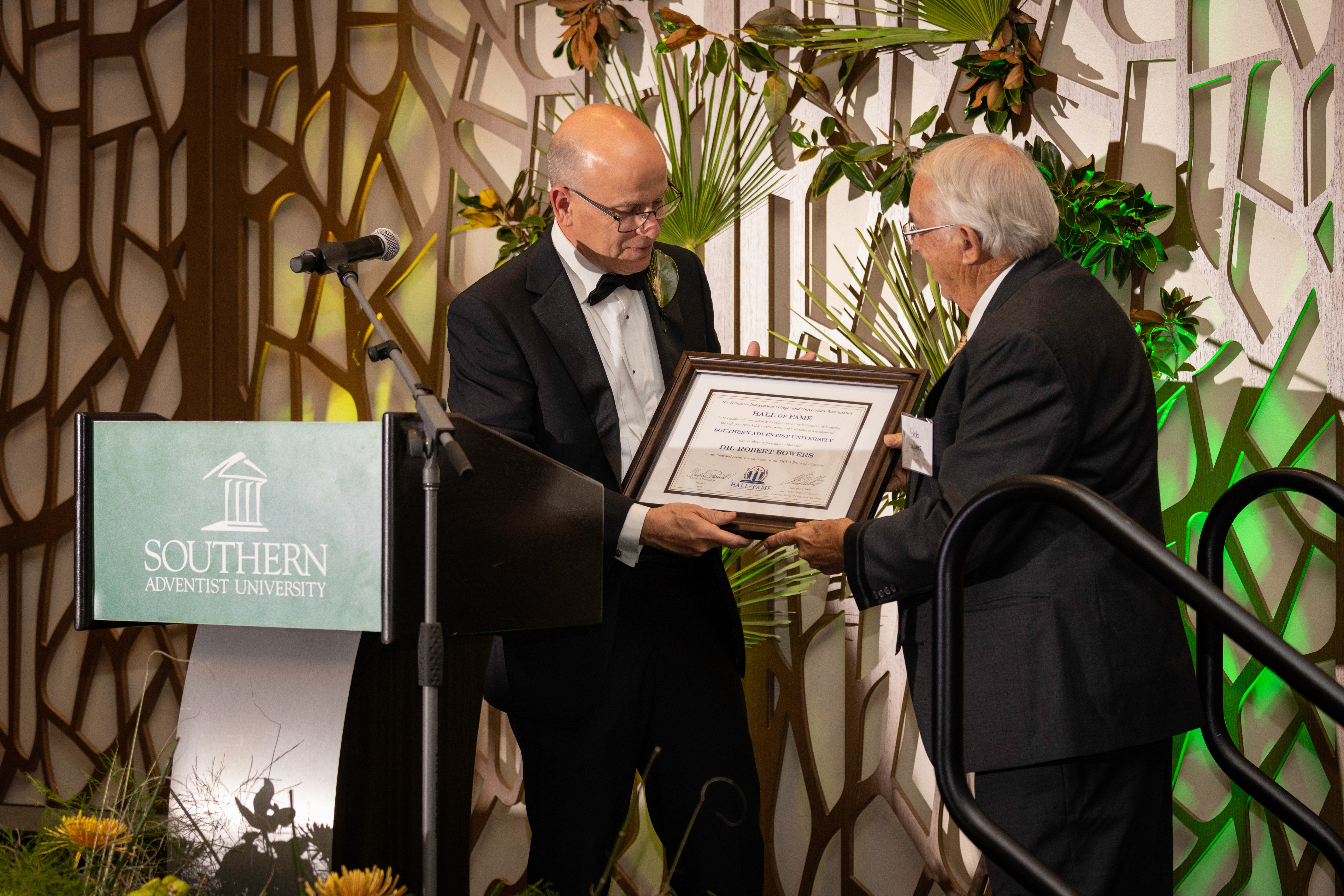 The Tennessee Independent Colleges and Universities Association (TICUA) Inductee Robert Bowers receives his Hall of Fame certificate from Ken Shaw, Southern Adventist University president.