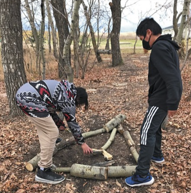 MANS students outside with tree limbs