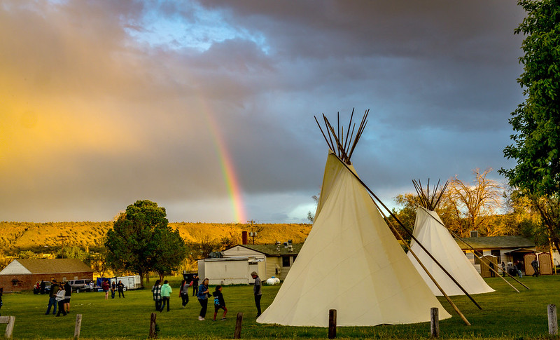 An end-of-day rainbow spreads across the sky as volunteers pack up for home. Photo By Dick Duerksen, Oregon Conference