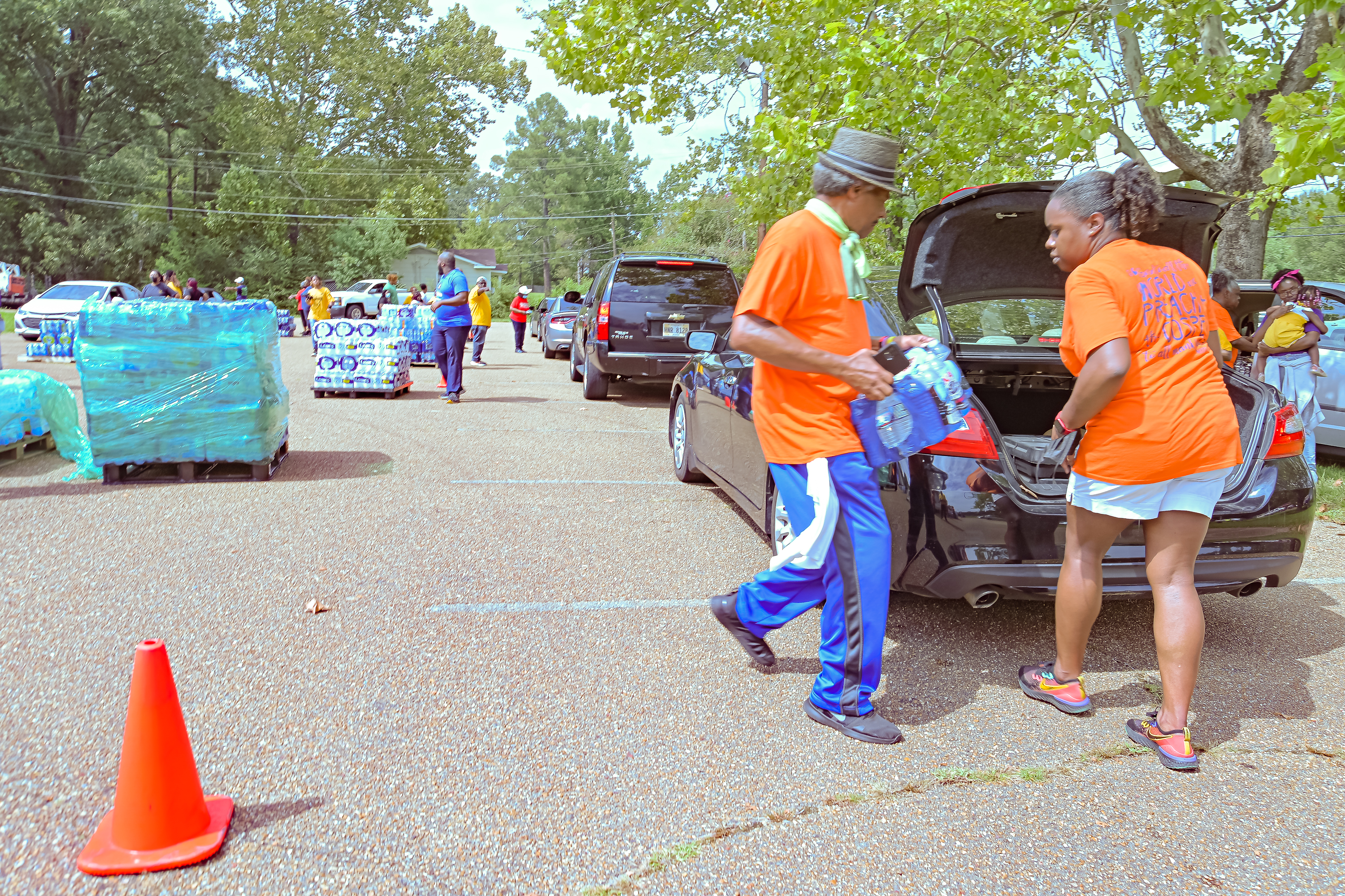 Local ACS volunteers in Jackson, Mississippi, place cases of bottled water in residents' vehicles during a water distribution event on Sept. 3, 2022. Photo provided by W. Derrick Lea/NAD ACS