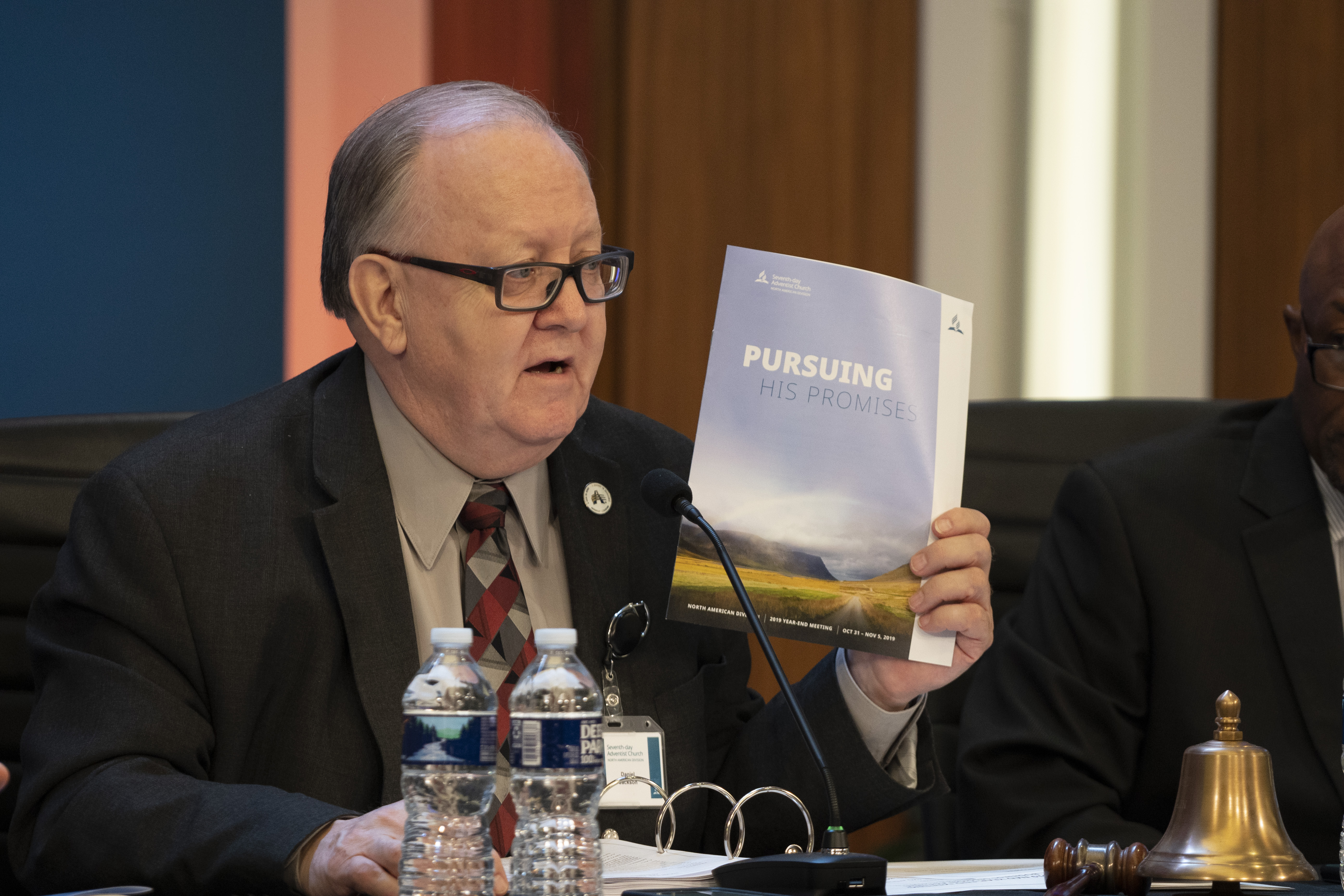 Daniel R. Jackson, holds up the program for the 2019 Year-End Meeting of the North American Division.