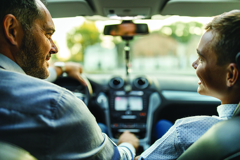 stock photo of father and son sitting in car