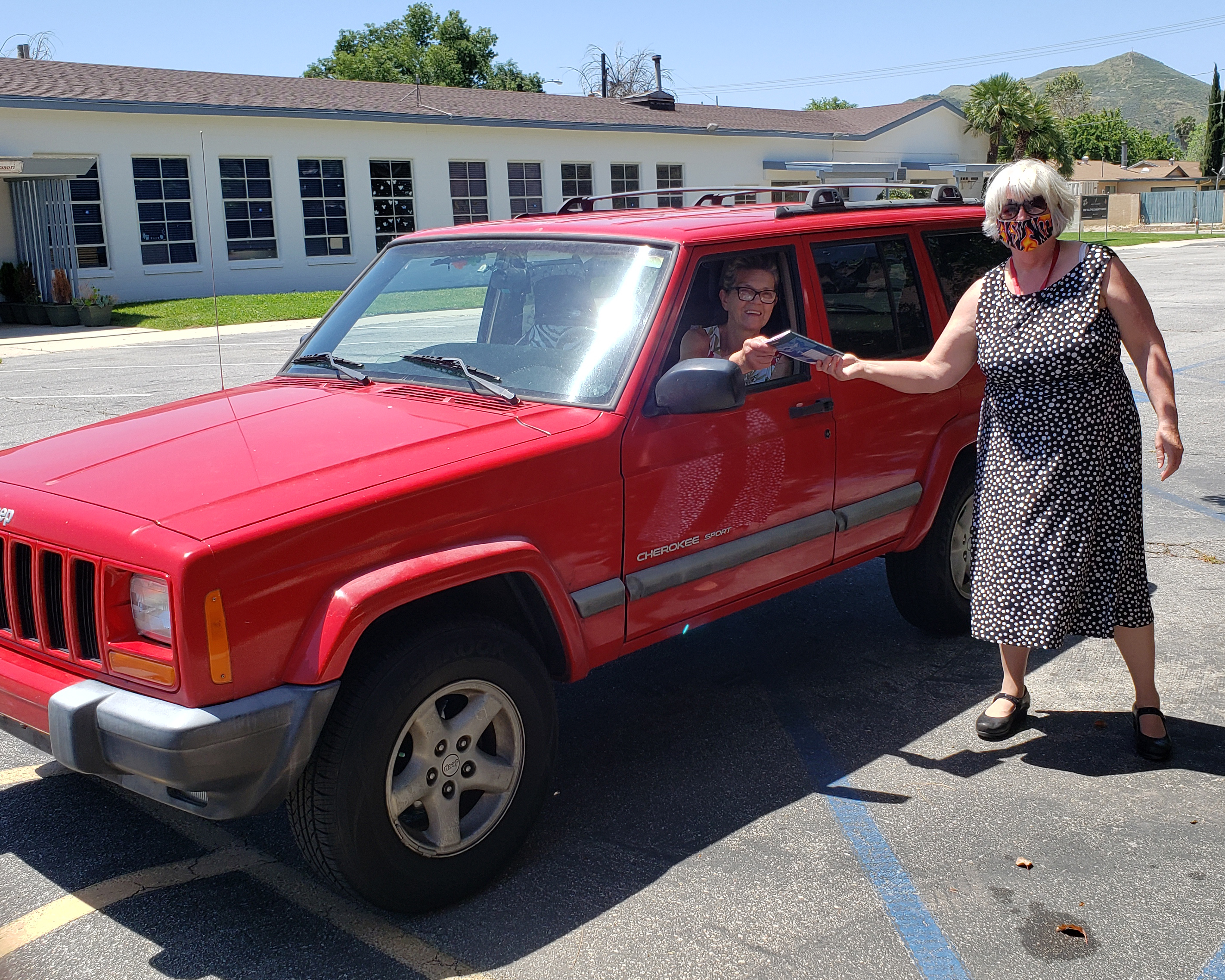 Pastor Jan gives a booklet at a "Drive-by Greeting"