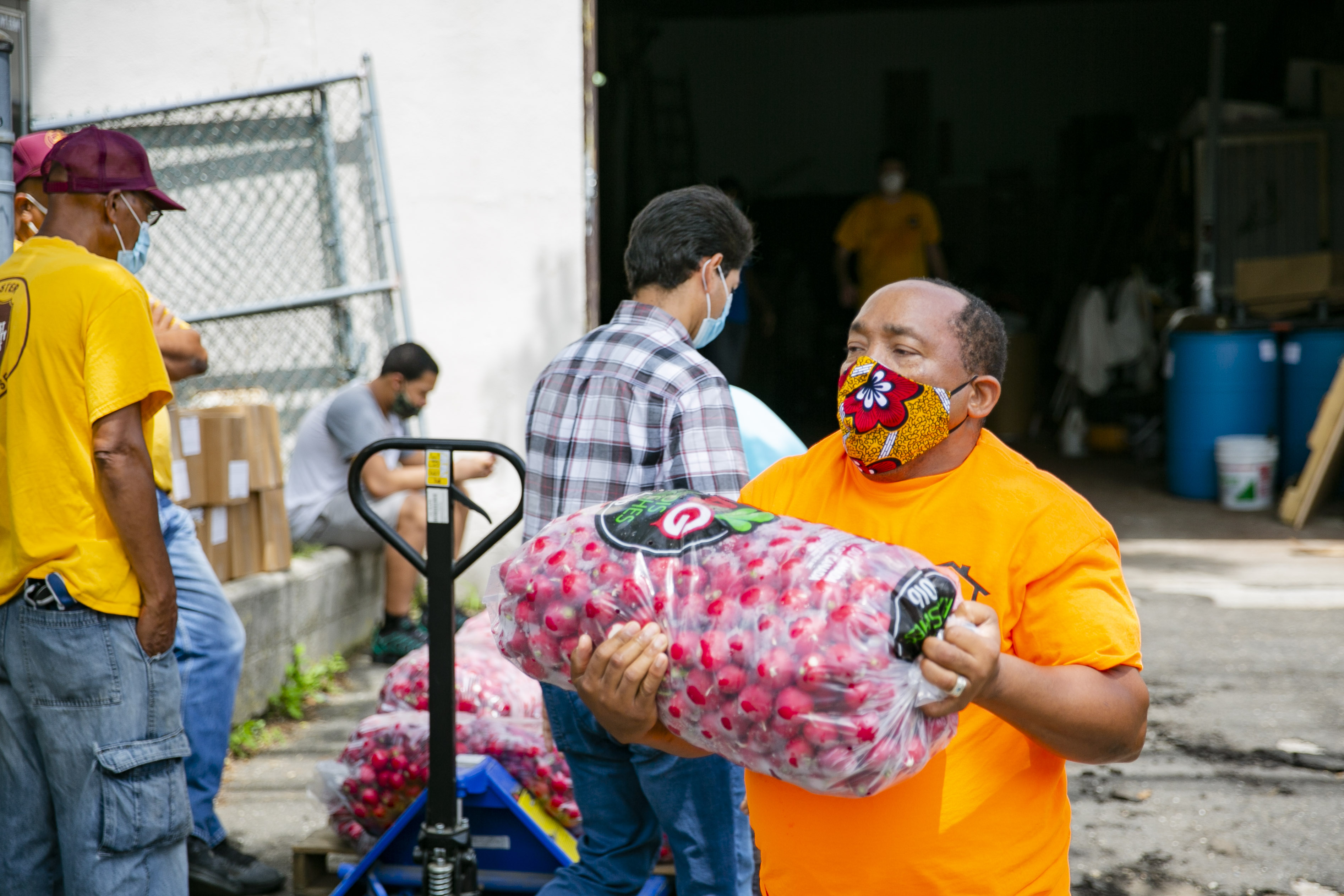 ACS workers unload produce from the City Harvest truck that delivered 12 pallets of food on July 13. Photo: JeNean Lendor