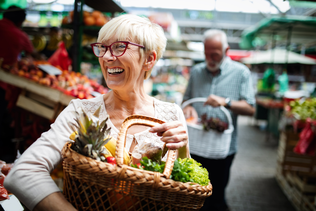 elderly couple grocery shopping stock photo