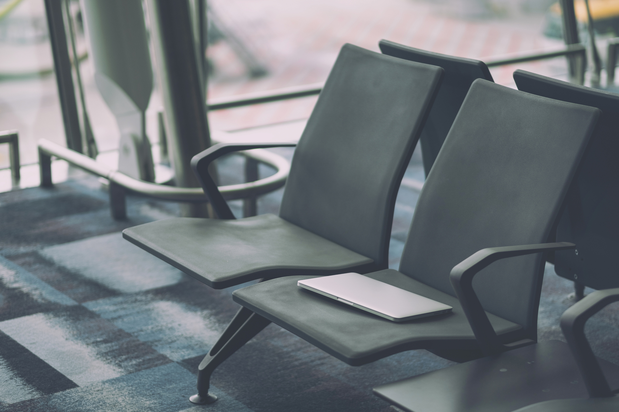 stock photo of laptop on airport seat