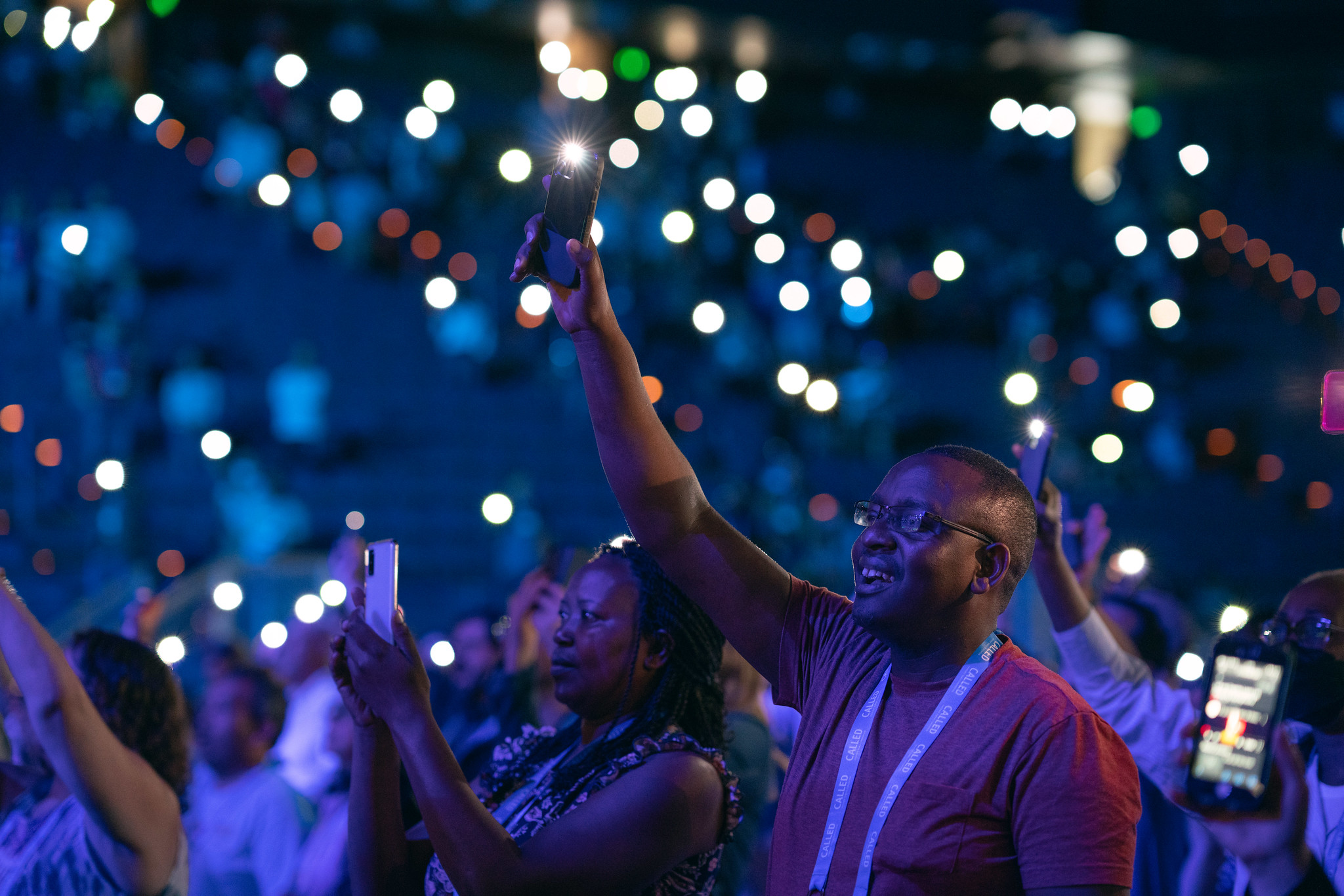 Attendees raise their phones in worship; photo by Pieter Damsteegt/NAD