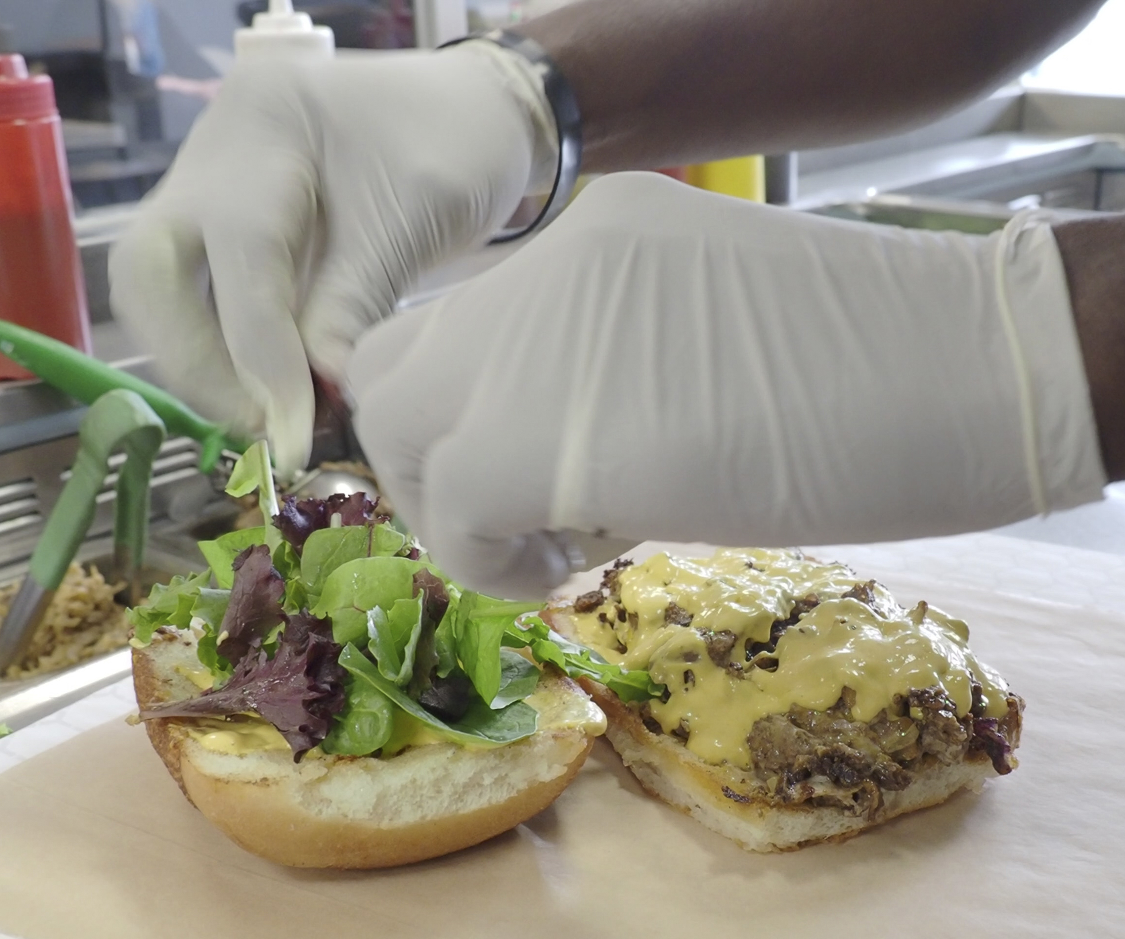 The final touches are made to a customer's order at The Veg Hub vegan restaurant in Oakland, California. The restaurant is an Adventist center of influence. Photo by Dan Weber