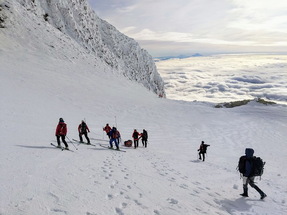 Emergency response team transports patient down the mountain