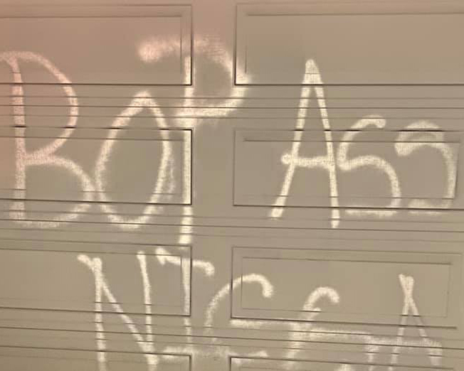 denver pastor experiences hate crime spray painted words on garage door