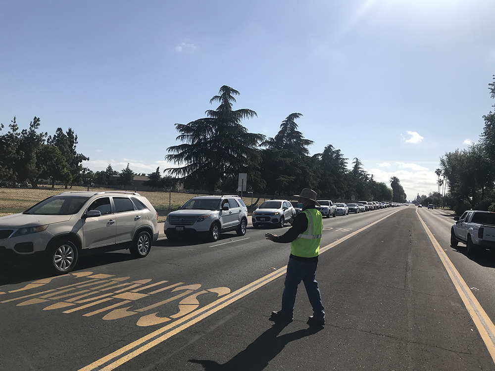 A church member helps direct traffic at the "U Matter to God" event, where volunteers from eight Adventist churches got together to serve more than 1,000 cars (4,302 people).