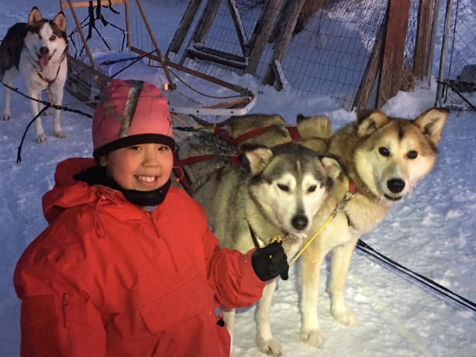 Haley, the Evans' adopted daughter, poses with her dog team. One of Haley's hobbies is mushing. Photo provided by Shoni Evans