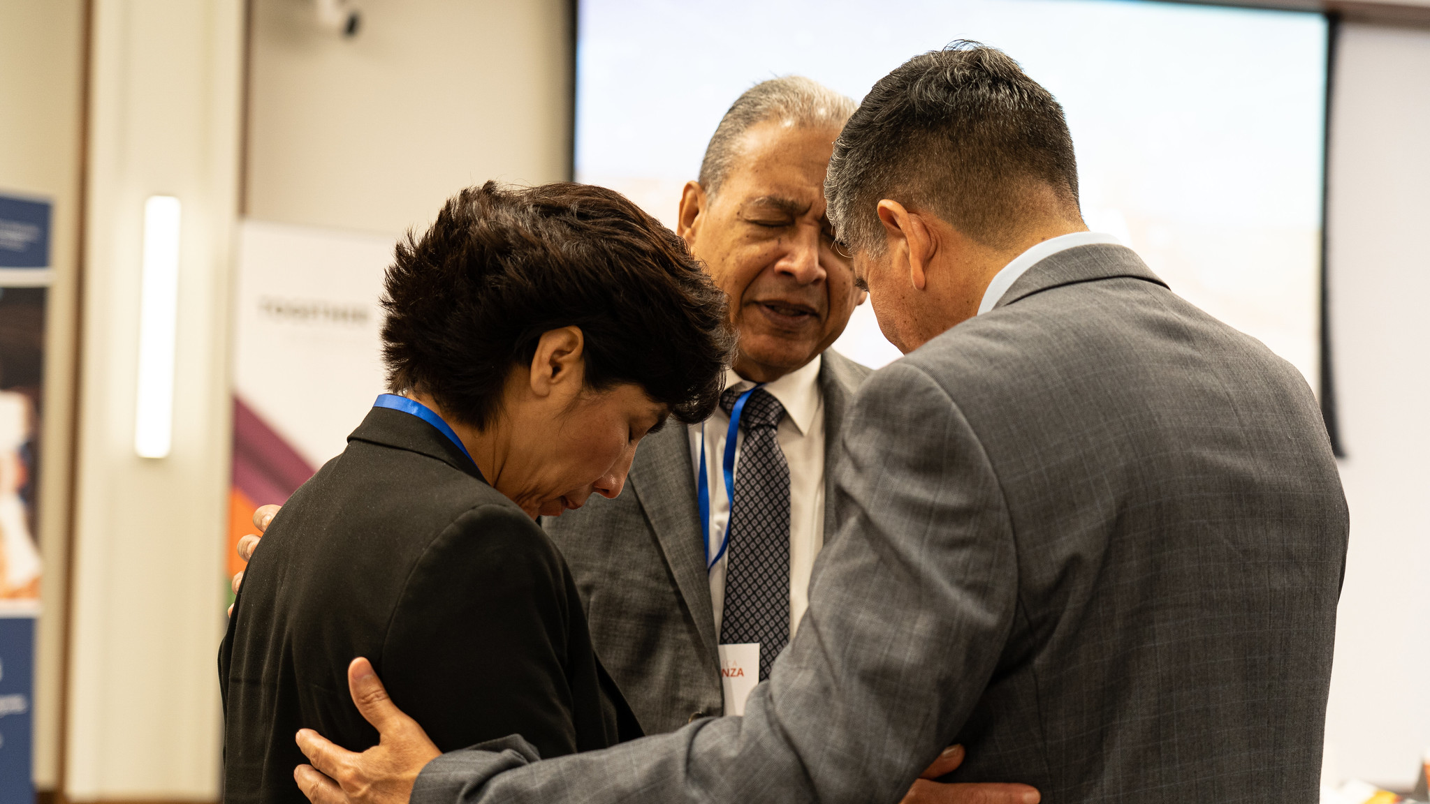 Hispanic Ministries coordinators pray for each other during worship on Tuesday morning. Photo by Art Brondo/NAD