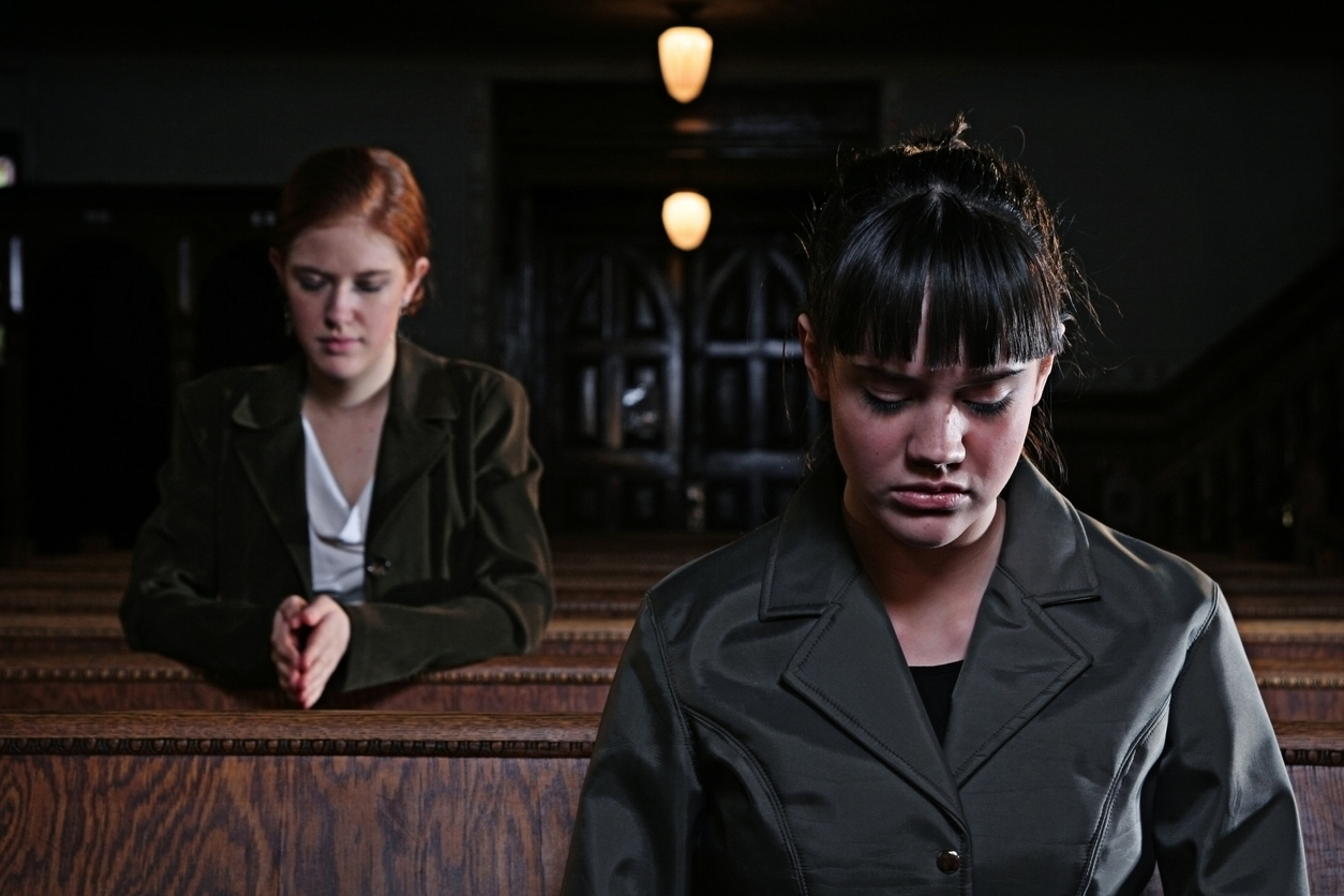 stock photo two women praying in church