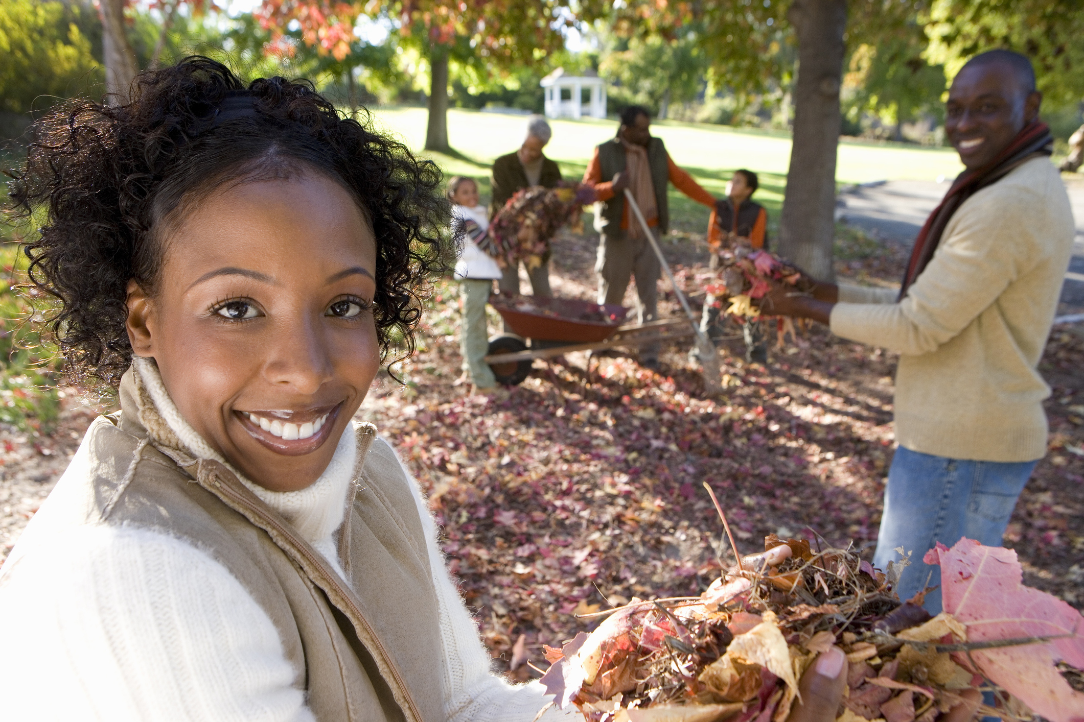 stock photo of family raking yard