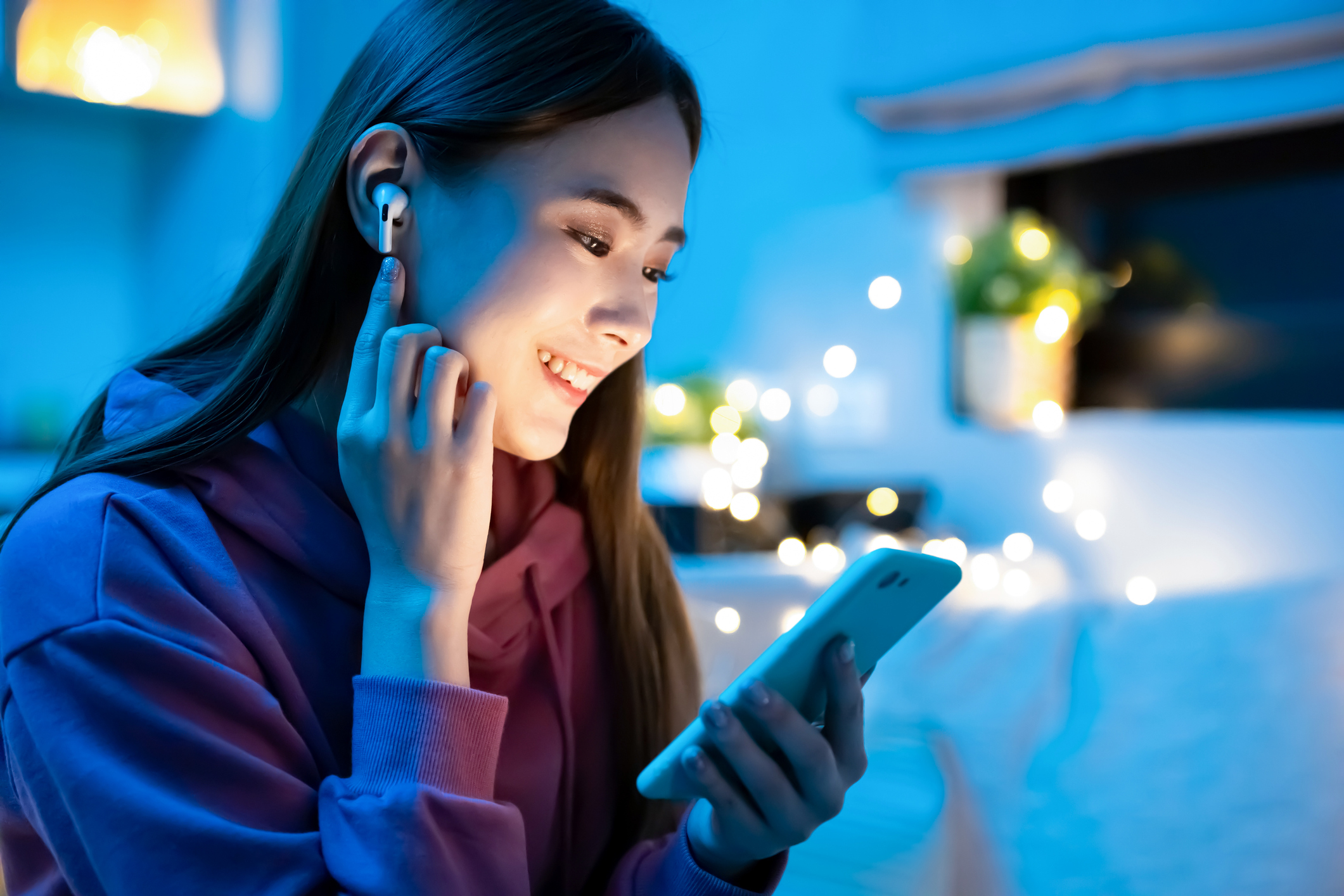 stock photo Asian woman listening to podcast